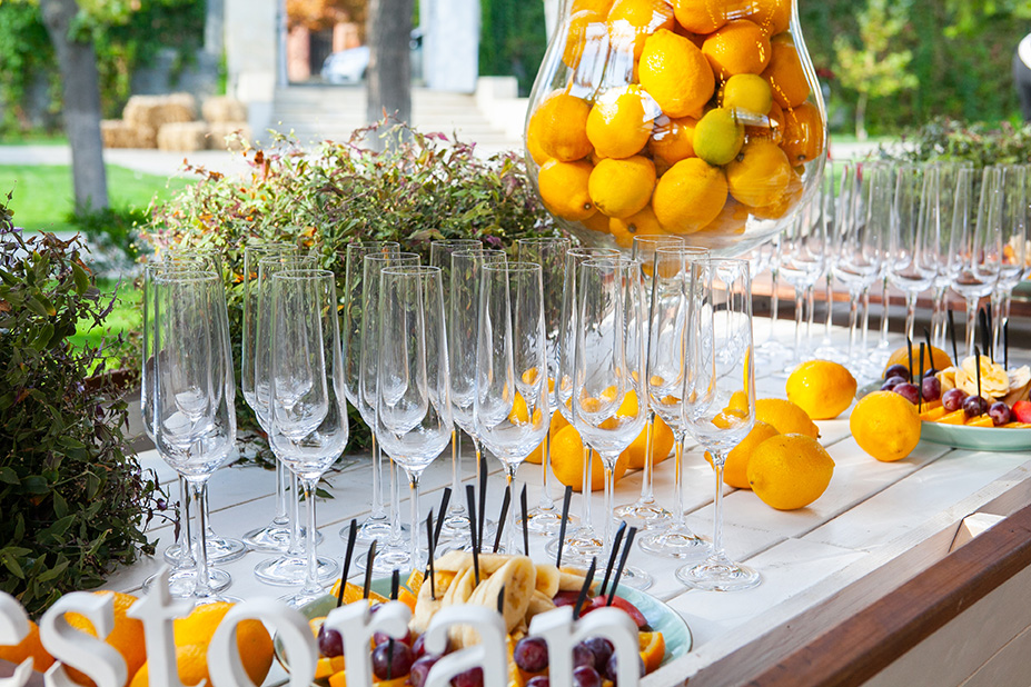 prepared tables for the celebration with tables and equipment decorated with flowers in a restaurant